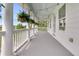 Spacious balcony featuring white columns, string lights, and views of lush greenery at 2197 Sandy Point Ln, Mount Pleasant, SC 29466