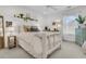 Serene bedroom with a white bed frame, complemented by natural light and stylish decor at 2197 Sandy Point Ln, Mount Pleasant, SC 29466