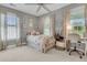 Charming bedroom with a floral bedspread, accent pillows, and lots of natural light at 2197 Sandy Point Ln, Mount Pleasant, SC 29466