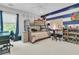 Fun bedroom with bunk beds, a desk, and blue and white striped accent wall at 2197 Sandy Point Ln, Mount Pleasant, SC 29466