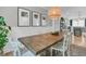 Charming dining room with a wooden table, white chairs, elegant lighting, and natural decor at 2197 Sandy Point Ln, Mount Pleasant, SC 29466