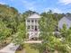 Charming two-story home with double porches surrounded by mature trees and lush landscaping at 2197 Sandy Point Ln, Mount Pleasant, SC 29466