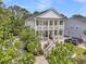 Stately two-story home with dual covered porches and steps leading to the entrance at 2197 Sandy Point Ln, Mount Pleasant, SC 29466