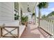 Comfortable front porch with overhead fans, white columns, ample seating, and hanging plants for relaxing outdoors at 2197 Sandy Point Ln, Mount Pleasant, SC 29466