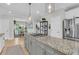 Open-concept kitchen with stainless steel appliances, gas cooktop, granite countertops, and pendant lighting at 2197 Sandy Point Ln, Mount Pleasant, SC 29466