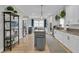 Spacious kitchen with a gray island, white cabinets, modern appliances, and hardwood floors at 2197 Sandy Point Ln, Mount Pleasant, SC 29466