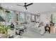 Open-concept living room with comfortable seating, large windows, and view to the staircase at 2197 Sandy Point Ln, Mount Pleasant, SC 29466