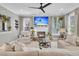 Inviting living room with a fireplace, large TV, comfortable seating, and stylish decor at 2197 Sandy Point Ln, Mount Pleasant, SC 29466