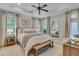 Bright and airy main bedroom with a large bed, neutral decor, and a tray ceiling with fan at 2197 Sandy Point Ln, Mount Pleasant, SC 29466