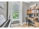 Well-lit office space featuring a modern desk setup, large window with natural light, and stylish decor at 2197 Sandy Point Ln, Mount Pleasant, SC 29466