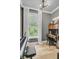 Well-lit office space featuring a modern desk setup, large window with natural light, and stylish decor at 2197 Sandy Point Ln, Mount Pleasant, SC 29466