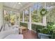 Inviting screened porch with comfortable seating, overhead lights, and scenic views at 2197 Sandy Point Ln, Mount Pleasant, SC 29466