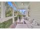 Relaxing screened porch with comfortable seating, stylish decor, and views of the surrounding landscape at 2197 Sandy Point Ln, Mount Pleasant, SC 29466