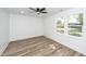 Bright bedroom with vinyl floors, ceiling fan and two windows at 2219 Eagle Dr, North Charleston, SC 29406