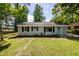 Well-maintained home featuring a vibrant green lawn and seafoam front door at 2219 Eagle Dr, North Charleston, SC 29406