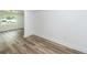 Hallway with wood-look floors and bright white walls, leading to other rooms at 2219 Eagle Dr, North Charleston, SC 29406