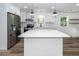 Bright, remodeled kitchen with stainless steel appliances, island, and hardwood floors at 2219 Eagle Dr, North Charleston, SC 29406