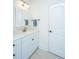 Bright bathroom with a white vanity, marble countertop, tiled floors, and a framed mirror and towel bar at 2324 High Tide Dr, Charleston, SC 29414