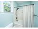 Bathroom featuring a white shower/tub combo, a shower curtain and a large window for natural light at 2324 High Tide Dr, Charleston, SC 29414
