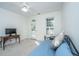 Bright bedroom featuring a daybed, TV, and access to a balcony through a glass door at 2324 High Tide Dr, Charleston, SC 29414