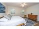 Bright bedroom with hardwood floors, two windows, and a king-sized bed at 2324 High Tide Dr, Charleston, SC 29414