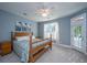 Bright bedroom featuring a wood-framed bed, a ceiling fan and a private entrance to a balcony at 2324 High Tide Dr, Charleston, SC 29414