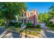 Beautifully landscaped two-story home with a double porch and a detached garage with a brick driveway at 2324 High Tide Dr, Charleston, SC 29414