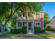 Charming two-story home features a double porch, lush landscaping, and a well-manicured front yard at 2324 High Tide Dr, Charleston, SC 29414