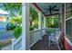 Inviting front porch with rocking chairs and a ceiling fan, perfect for relaxing and enjoying the outdoors at 2324 High Tide Dr, Charleston, SC 29414