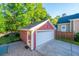 Beautiful exterior view of a detached garage with manicured lawn and brick driveway at 2324 High Tide Dr, Charleston, SC 29414