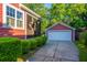 Exterior view of detached garage with beautiful manicured lawn and view to the house at 2324 High Tide Dr, Charleston, SC 29414