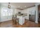 Bright kitchen features white cabinets, stainless steel appliances, hardwood floors, and a granite breakfast bar at 2324 High Tide Dr, Charleston, SC 29414