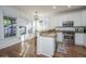 The kitchen has white cabinets, stainless appliances, an island, and hardwood floors at 2324 High Tide Dr, Charleston, SC 29414