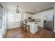 A bright kitchen featuring white cabinets, stainless steel appliances, and a hardwood floor at 2324 High Tide Dr, Charleston, SC 29414