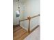 Well-lit staircase with hardwood steps, white railings, carpeted landing and modern pendant light at 2324 High Tide Dr, Charleston, SC 29414