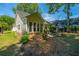 Backyard features a well-manicured lawn with green trees and landscaping at 2418 Tuscany Dr, North Charleston, SC 29406