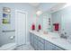 Bathroom featuring a double vanity, a large mirror, and neutral-toned walls at 2418 Tuscany Dr, North Charleston, SC 29406