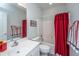 Cozy bathroom featuring a shower-tub combo with bright red shower curtain and classic white fixtures at 2418 Tuscany Dr, North Charleston, SC 29406