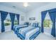 Bedroom featuring two single beds with a ceiling fan, and blue colored curtains at 2418 Tuscany Dr, North Charleston, SC 29406