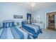 Light and airy bedroom featuring twin beds, white wicker furniture, and coastal decor at 2418 Tuscany Dr, North Charleston, SC 29406