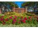 Brick community entrance with colorful flowers and landscaping at 2418 Tuscany Dr, North Charleston, SC 29406