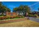 Community entrance with brick facade, flower beds, and manicured landscaping at 2418 Tuscany Dr, North Charleston, SC 29406