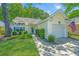 Charming yellow home with a lush front yard and inviting curb appeal at 2418 Tuscany Dr, North Charleston, SC 29406