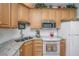 Kitchen boasts granite counters, white appliances, and ample cabinet space at 2418 Tuscany Dr, North Charleston, SC 29406
