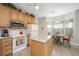 Eat in kitchen boasts countertops, white appliances, and an island at 2418 Tuscany Dr, North Charleston, SC 29406
