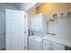 Efficient laundry area with stacked washer and dryer and counterspace at 2418 Tuscany Dr, North Charleston, SC 29406