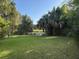 Spacious backyard featuring lush greenery, trees, and a black fence, creating a private and serene outdoor space at 255 Oak Point Landing Dr, Mount Pleasant, SC 29464