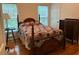 Bedroom featuring a full-sized bed, wood floors, a large window, and a dark-colored dresser at 255 Oak Point Landing Dr, Mount Pleasant, SC 29464