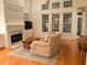 Light and airy living room showcases a fireplace, hardwood floors, and a comfortable couch at 255 Oak Point Landing Dr, Mount Pleasant, SC 29464