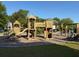 Community playground featuring wooden structures, swings, and benches, perfect for Gathering fun and outdoor activities at 255 Oak Point Landing Dr, Mount Pleasant, SC 29464